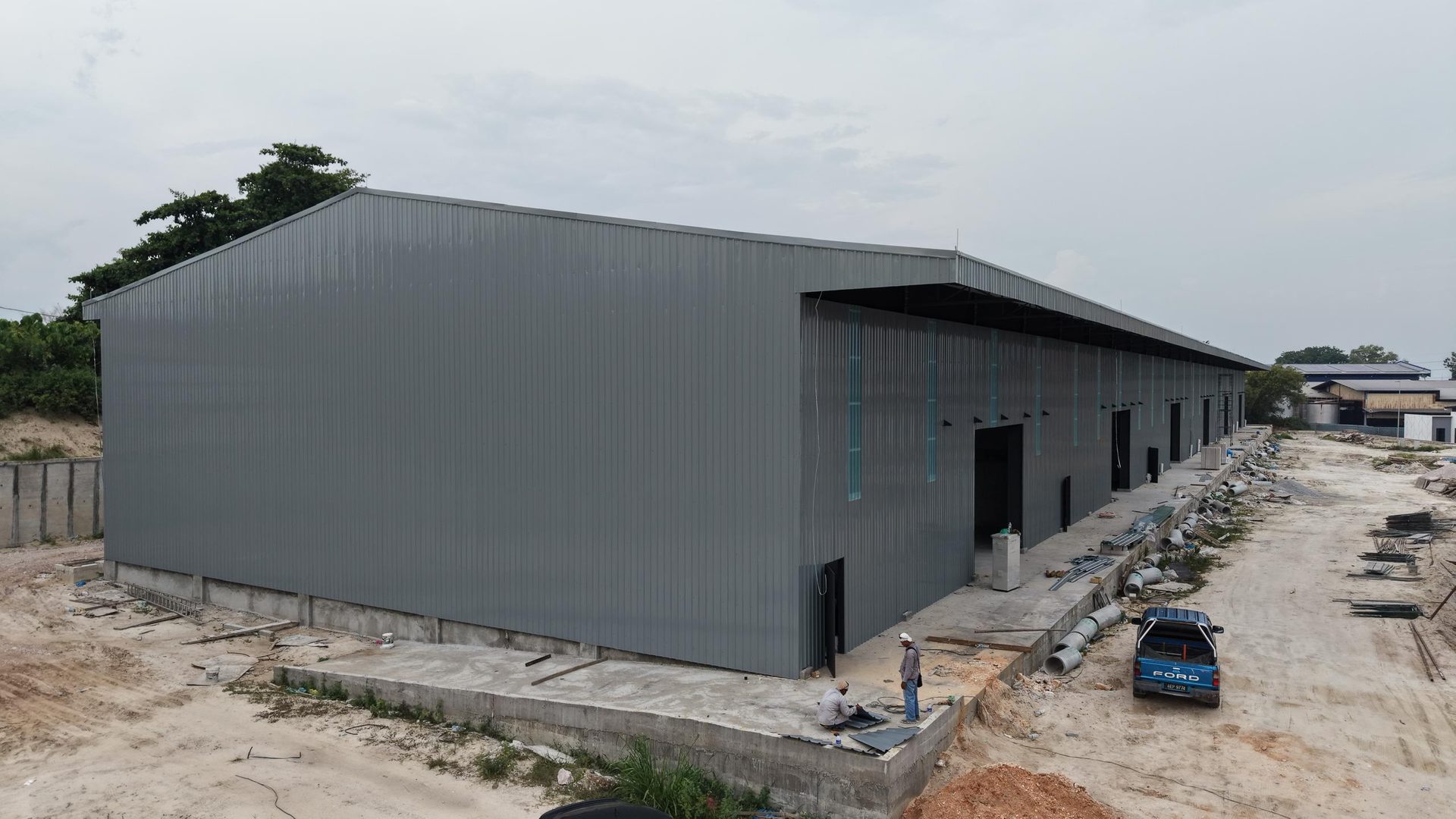 Ground-level view of the finished grey metal cladding and loading doors
