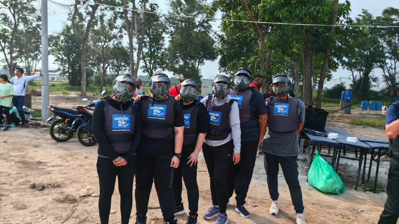 Paintball squad in full gear on the field